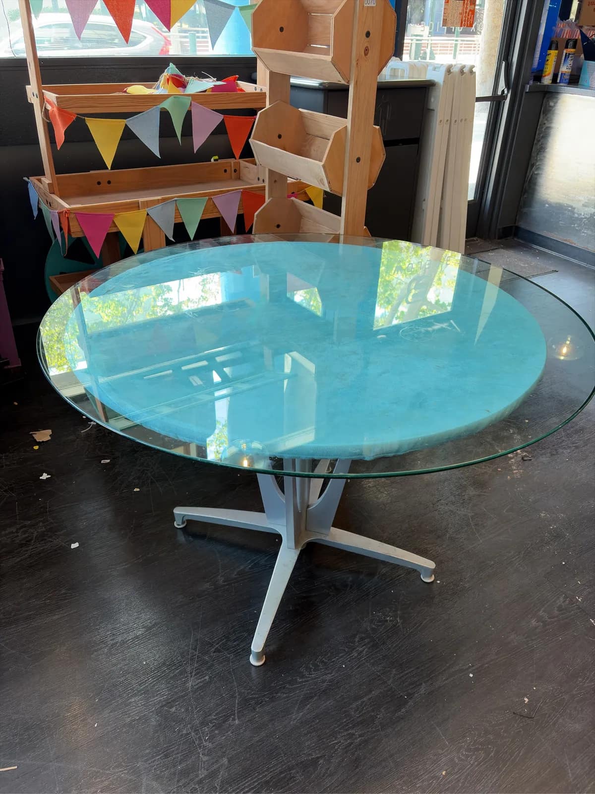 modern-round-glass-top-dining-table-with-metal-base-and-teal-fabric-undercover-d77b1d