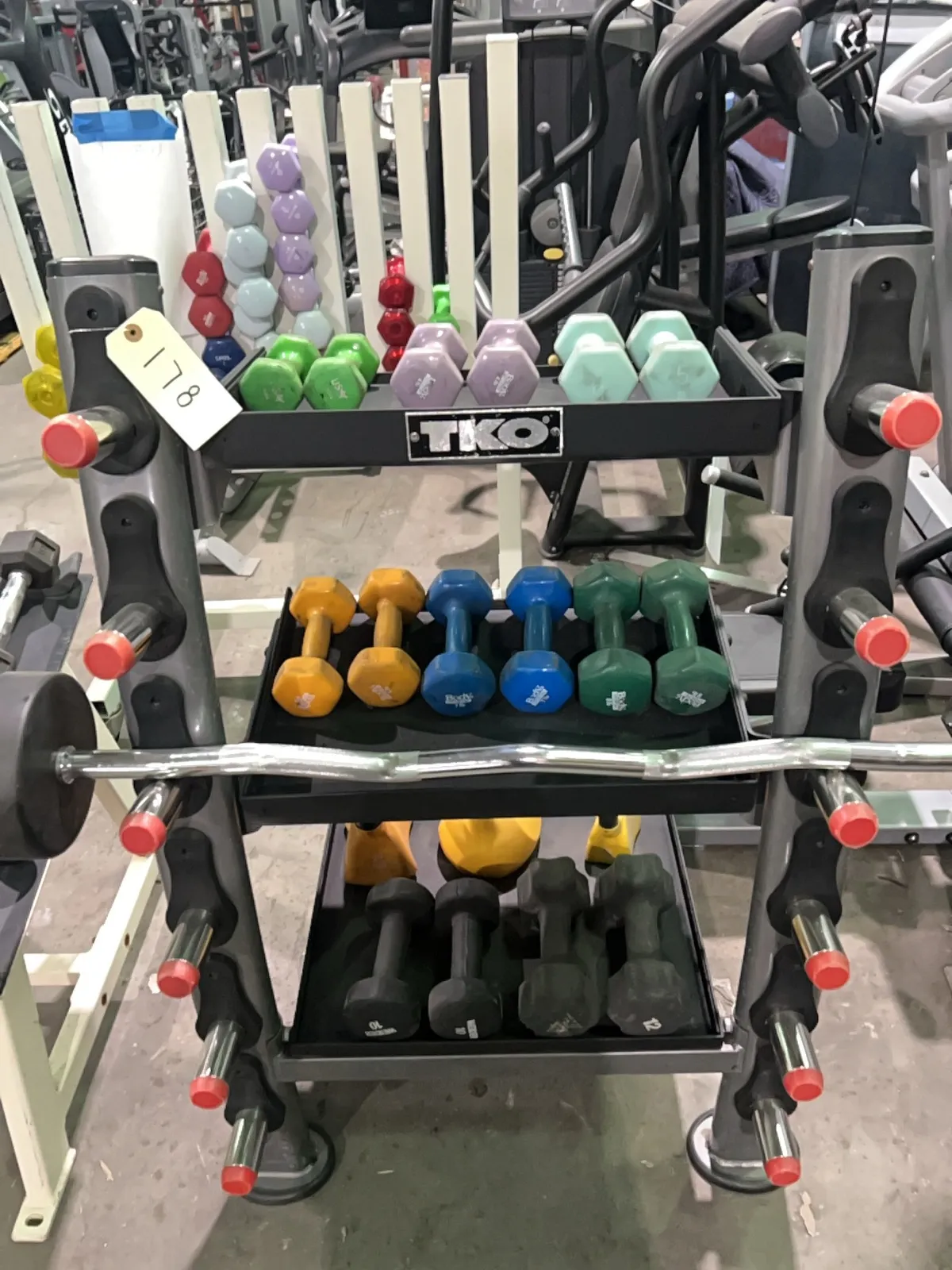 tko-stand-with-barbell-kettlebells-and-dumbells-mqqs90wn