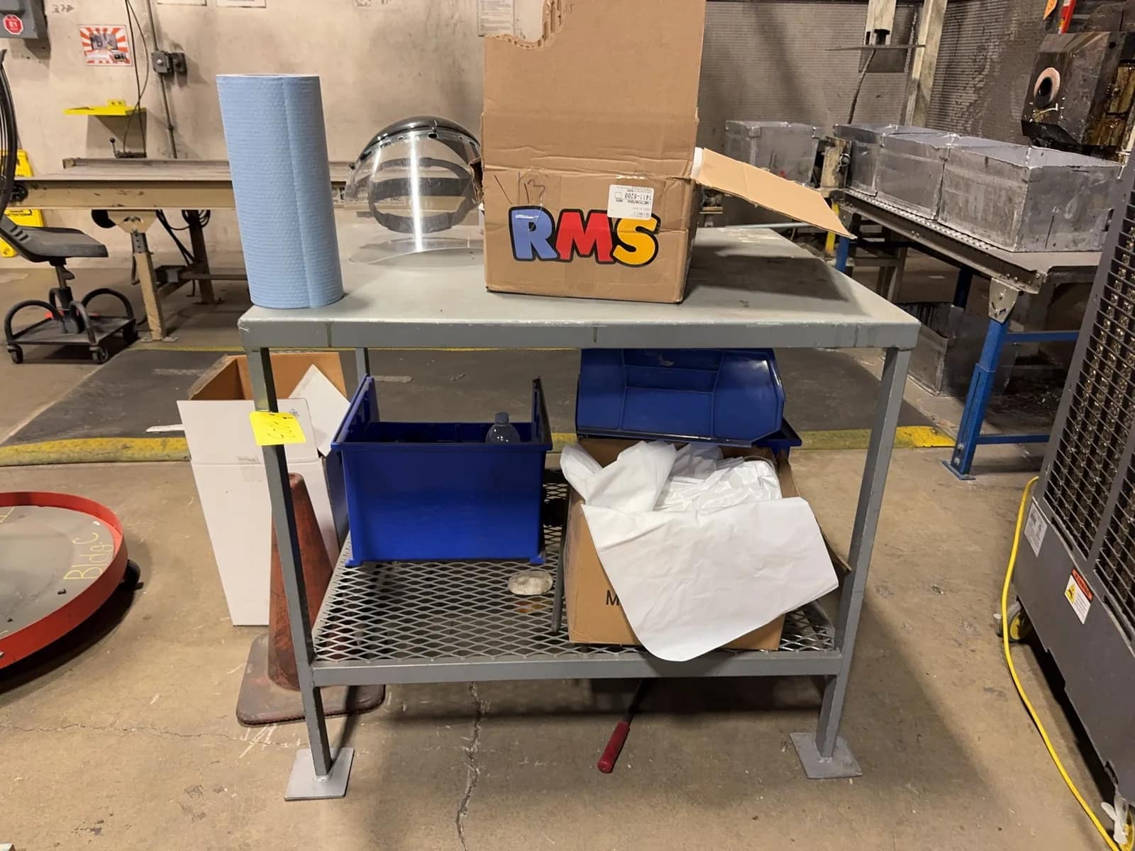 metal-table-with-contents-towels-safety-gear-and-more-mrjz92lf