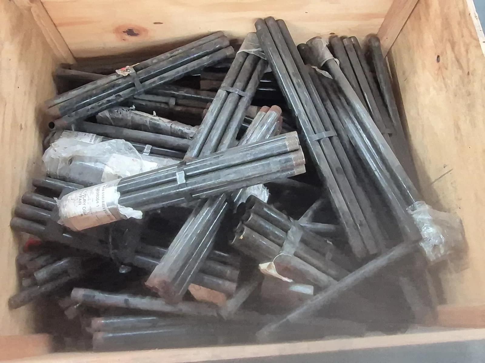 contents-of-pallet-various-threaded-steel-drill-rods-or-drill-pipes-with-visible-male-pin-ends-mueem0u3