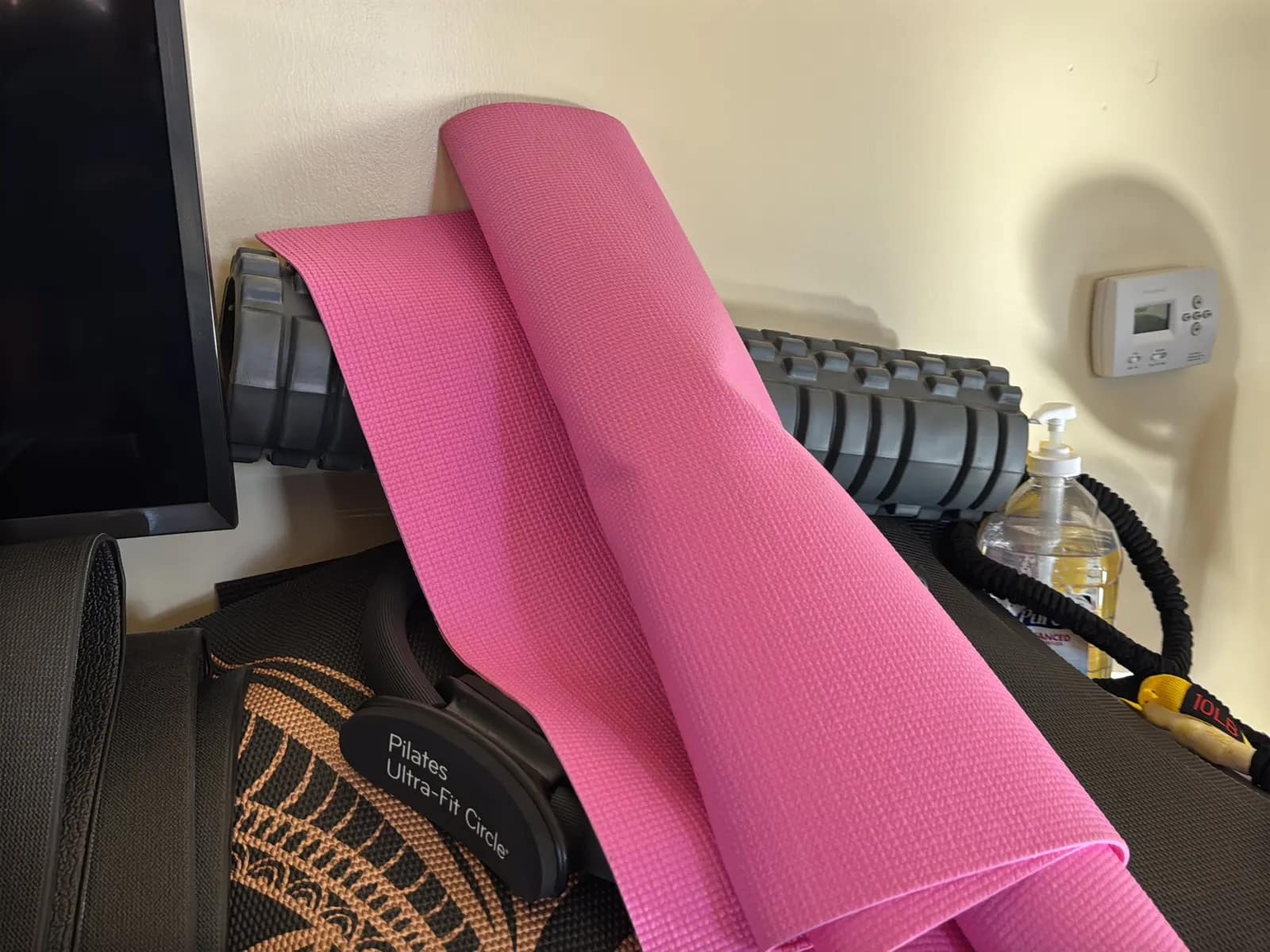 Contents Of Countertop: Kettlebells, Rubber Bands, Peloton Accessories, Yoga Mats, Pilates Equipment, And Machine Parts, photo 13 of 19