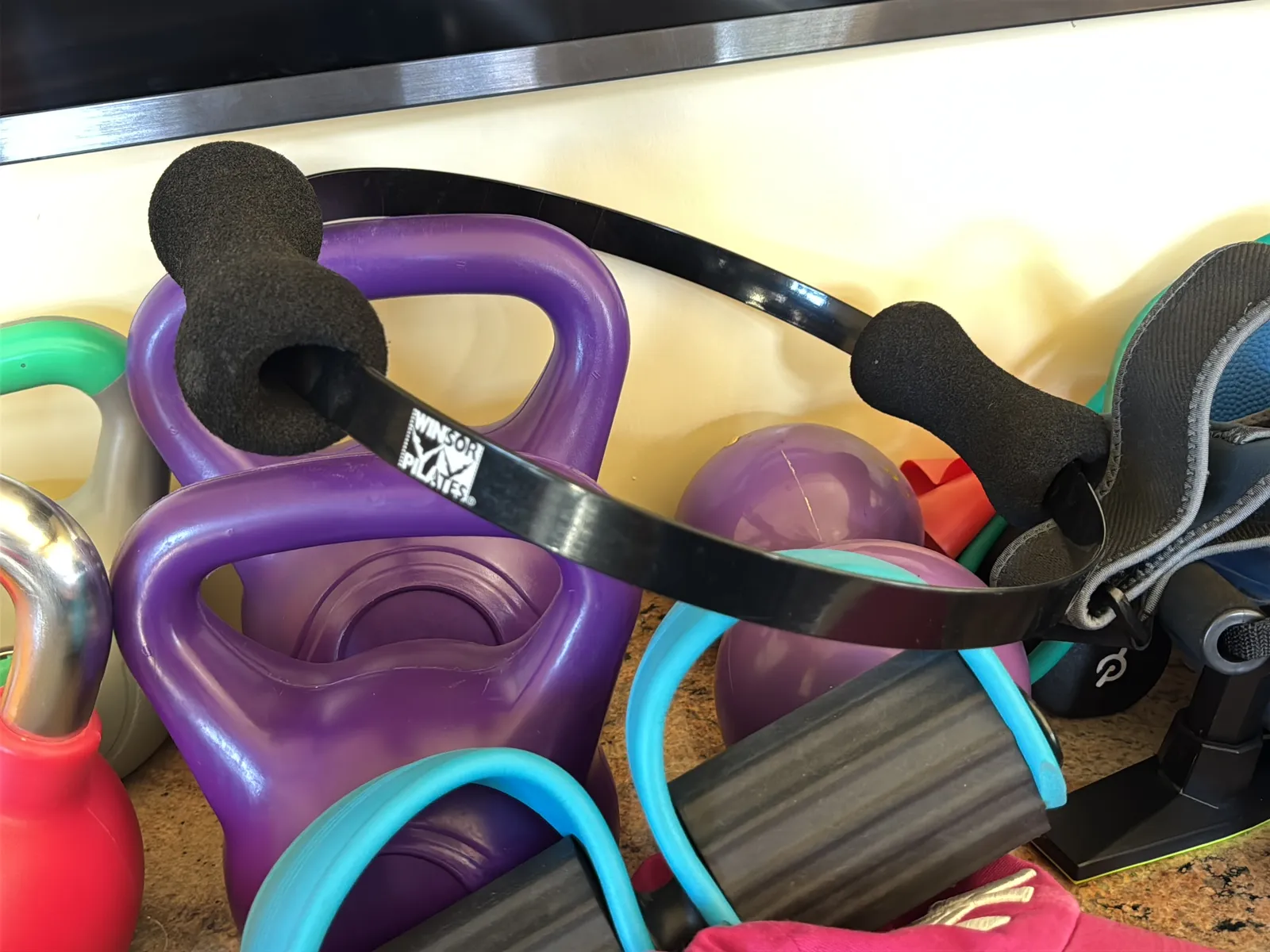 Contents Of Countertop: Kettlebells, Rubber Bands, Peloton Accessories, Yoga Mats, Pilates Equipment, And Machine Parts, photo 9 of 19