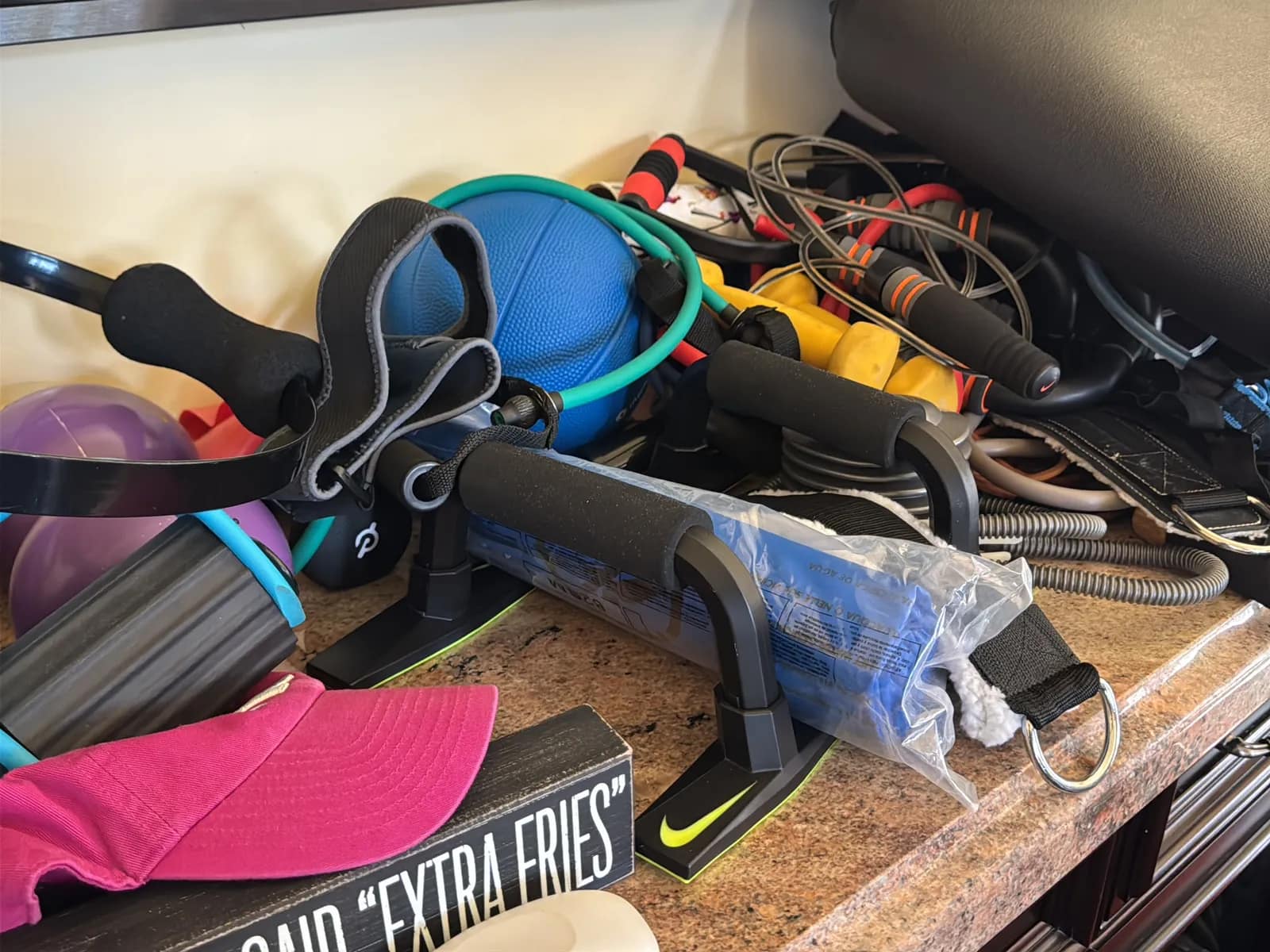 Contents Of Countertop: Kettlebells, Rubber Bands, Peloton Accessories, Yoga Mats, Pilates Equipment, And Machine Parts, photo 7 of 19