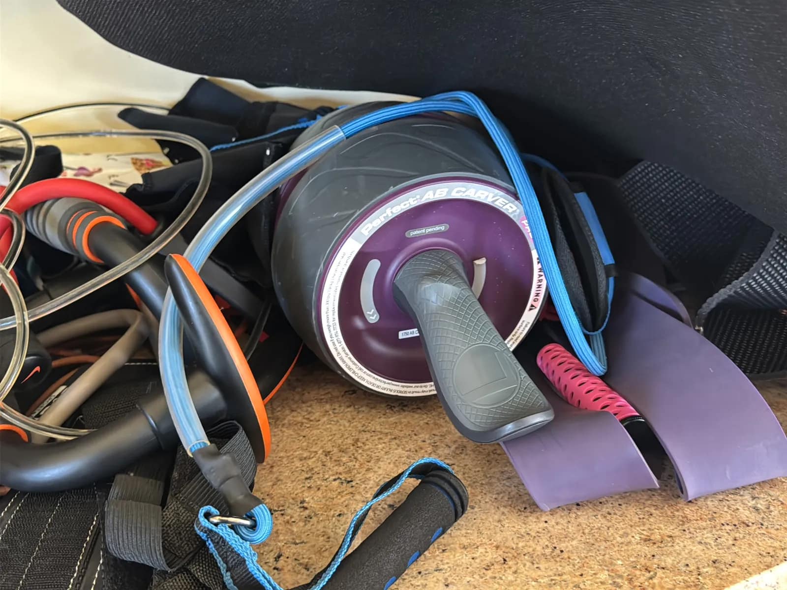 Contents Of Countertop: Kettlebells, Rubber Bands, Peloton Accessories, Yoga Mats, Pilates Equipment, And Machine Parts, photo 16 of 19