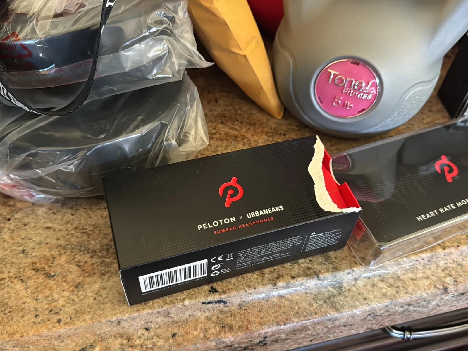 Contents Of Countertop: Kettlebells, Rubber Bands, Peloton Accessories, Yoga Mats, Pilates Equipment, And Machine Parts, photo 3 of 19