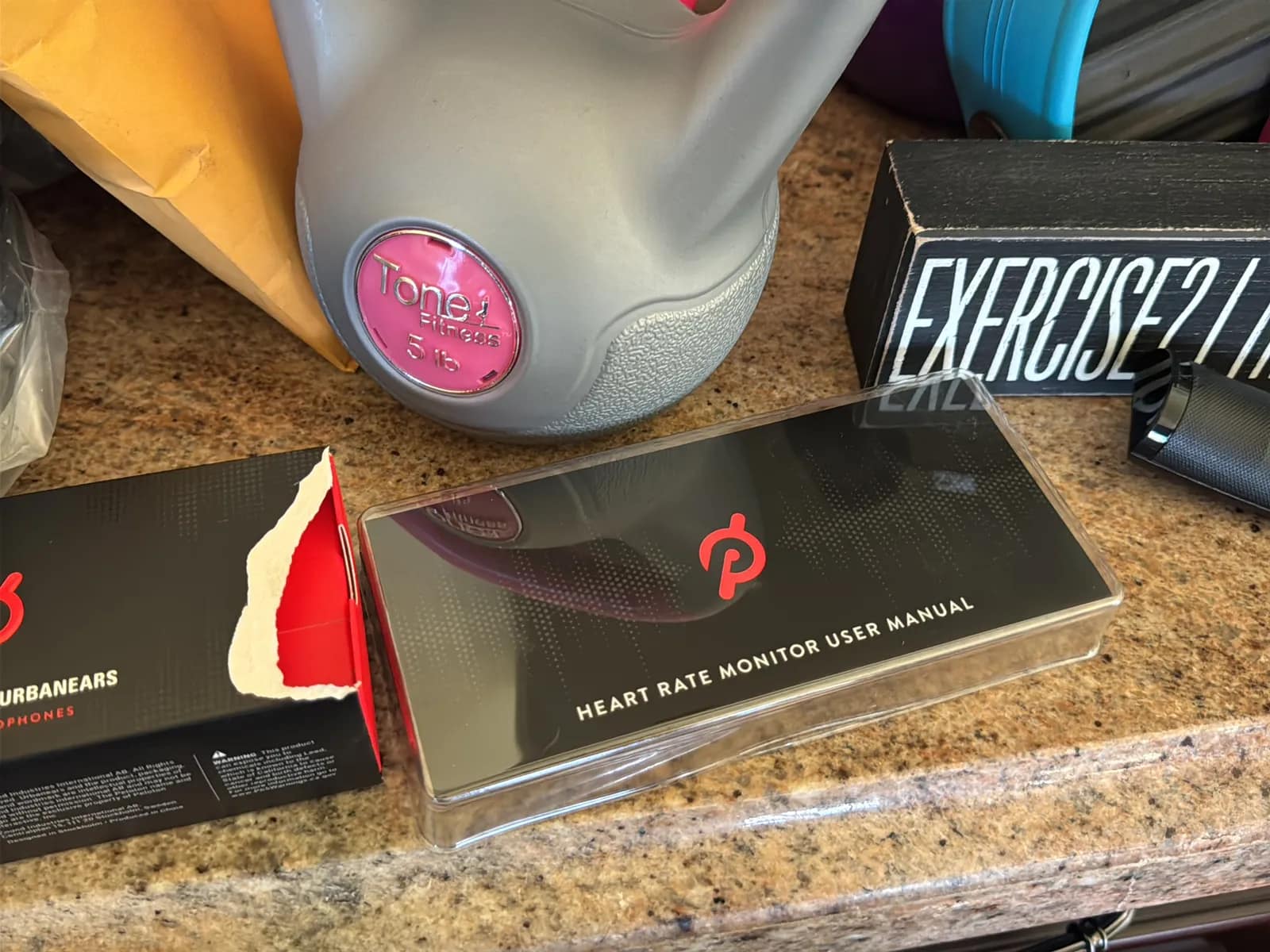 Contents Of Countertop: Kettlebells, Rubber Bands, Peloton Accessories, Yoga Mats, Pilates Equipment, And Machine Parts, photo 4 of 19