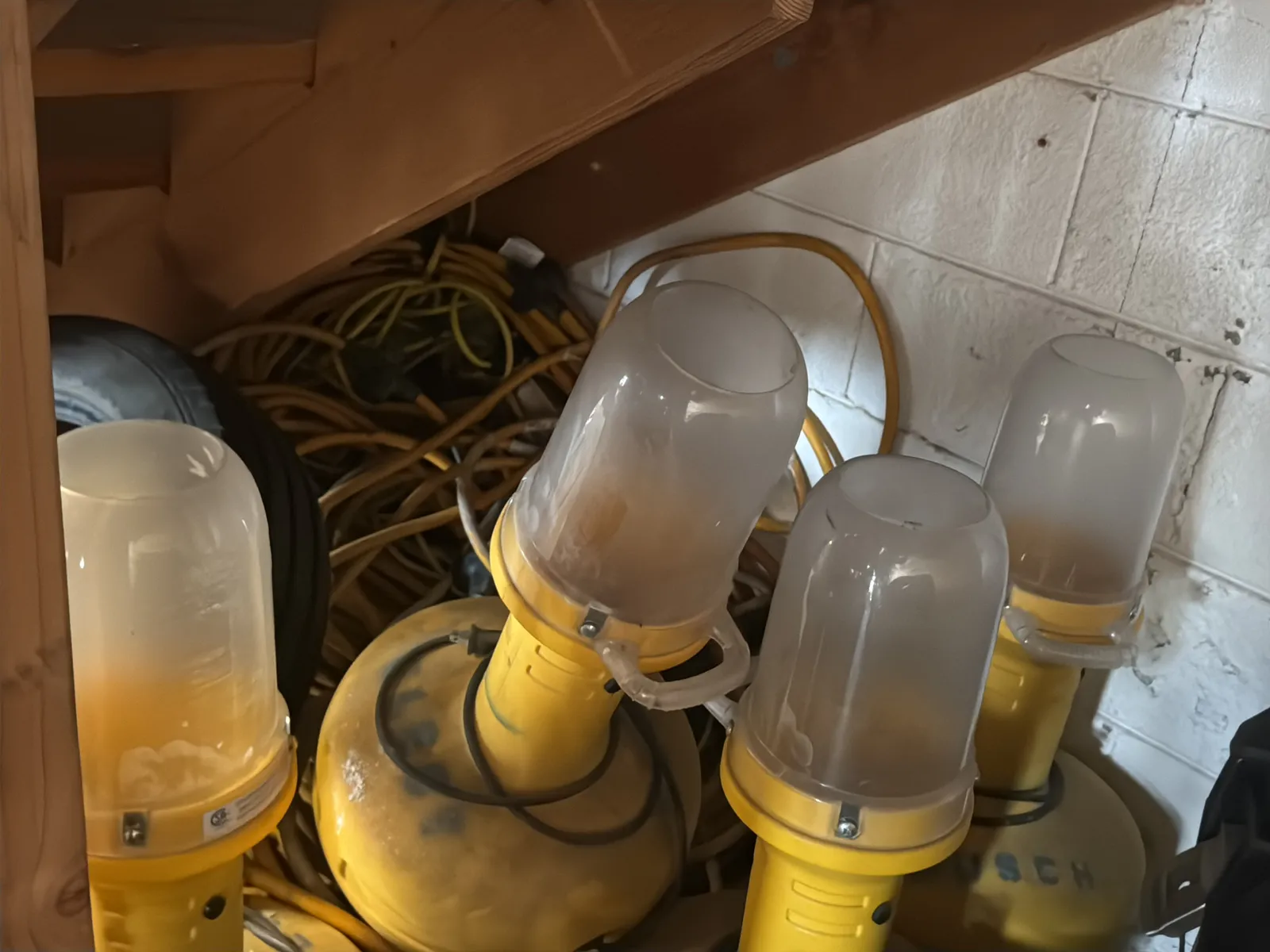 Contents Under Staircase: (2) Tires, Rolling Toolbox, Job-site Light Extension Cords, And Bricks., photo 10 of 15