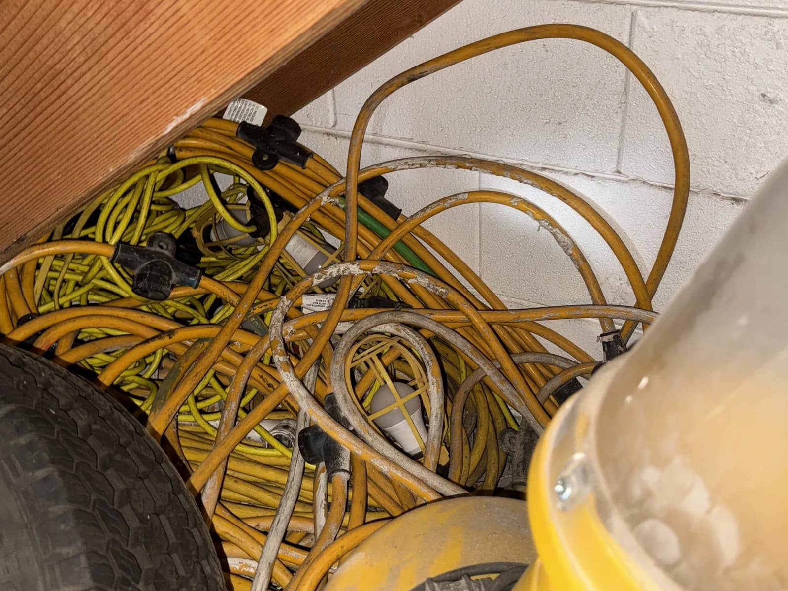 Contents Under Staircase: (2) Tires, Rolling Toolbox, Job-site Light Extension Cords, And Bricks., photo 13 of 15