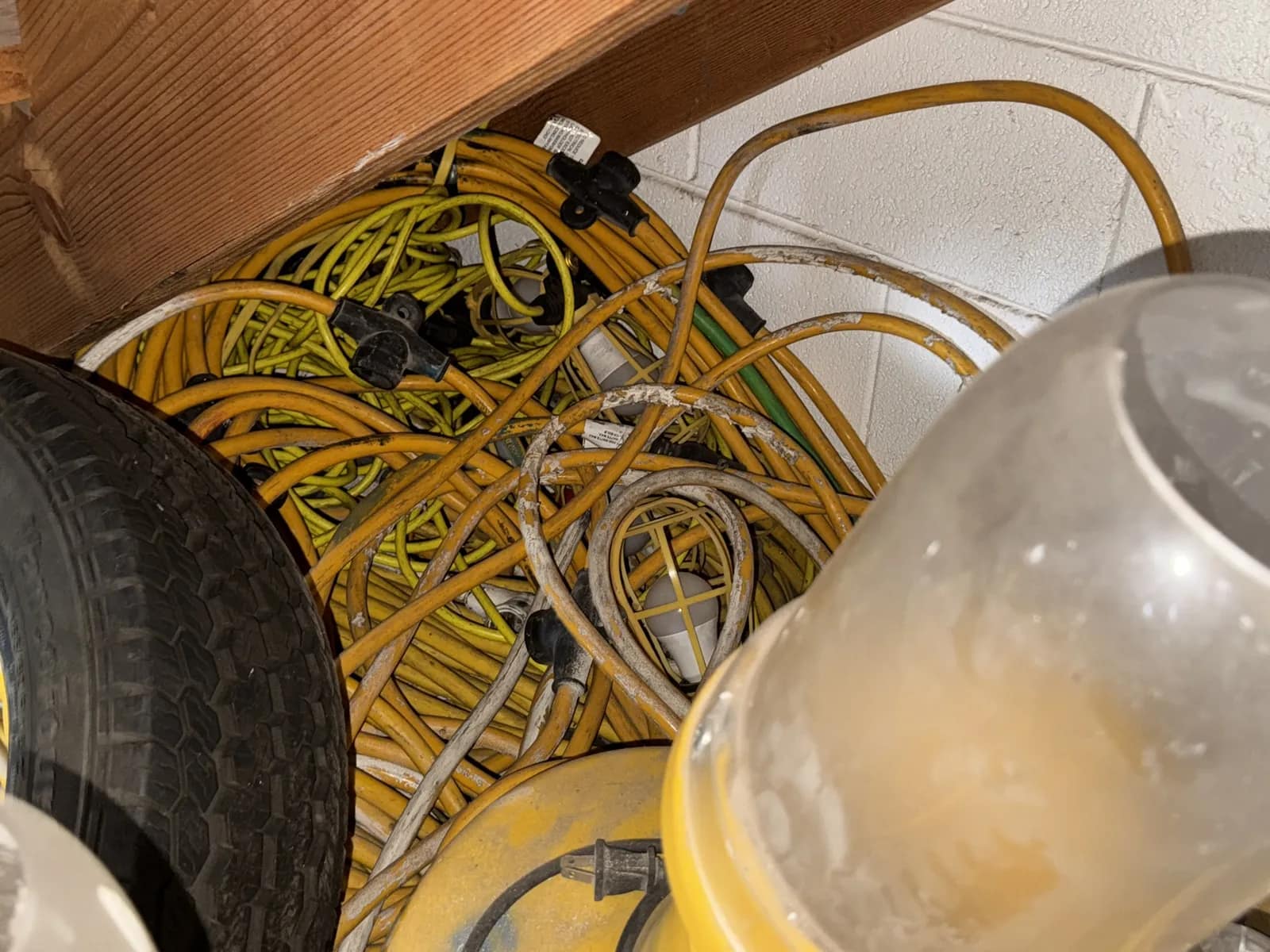 Contents Under Staircase: (2) Tires, Rolling Toolbox, Job-site Light Extension Cords, And Bricks., photo 12 of 15