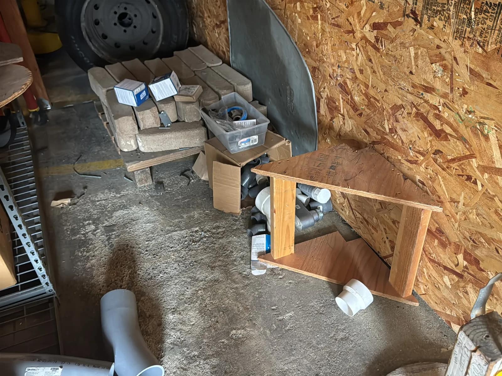 Contents Under Staircase: (2) Tires, Rolling Toolbox, Job-site Light Extension Cords, And Bricks., photo 2 of 15