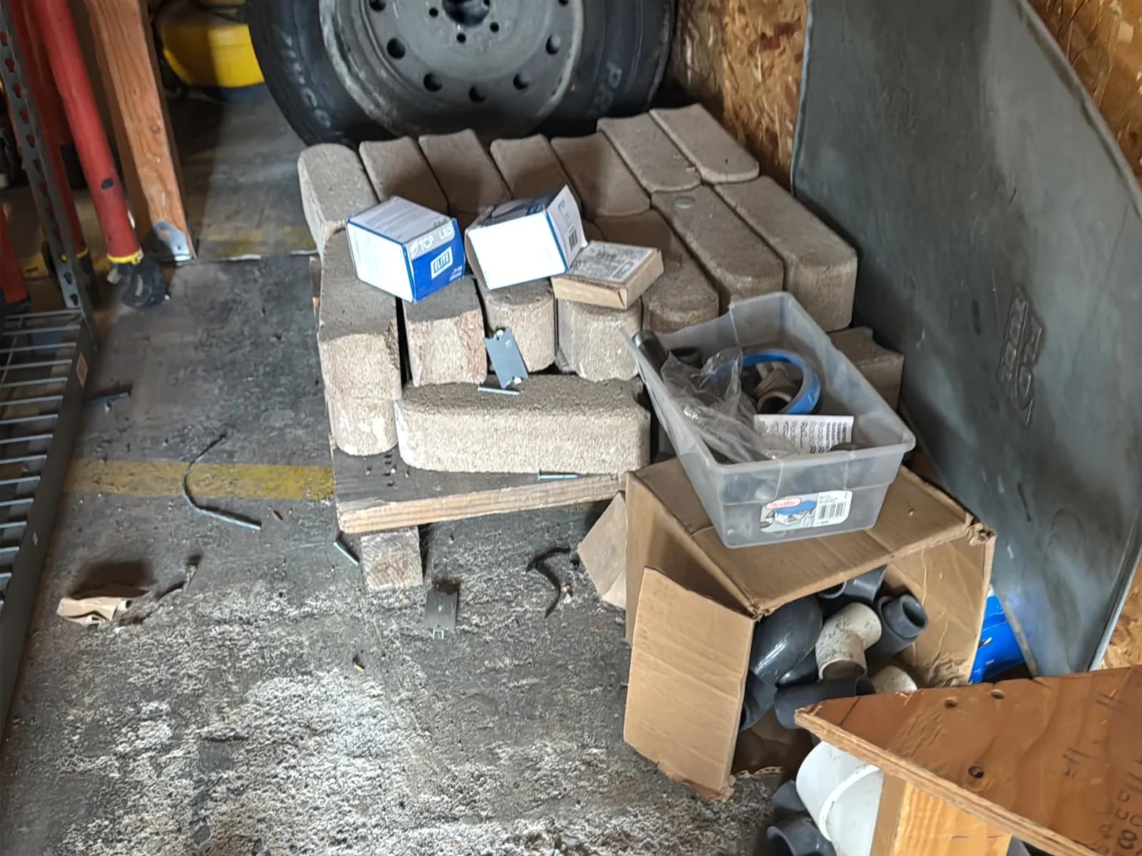 Contents Under Staircase: (2) Tires, Rolling Toolbox, Job-site Light Extension Cords, And Bricks., photo 3 of 15