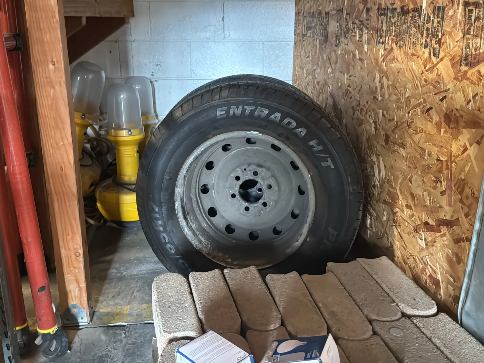 Contents Under Staircase: (2) Tires, Rolling Toolbox, Job-site Light Extension Cords, And Bricks., photo 4 of 15