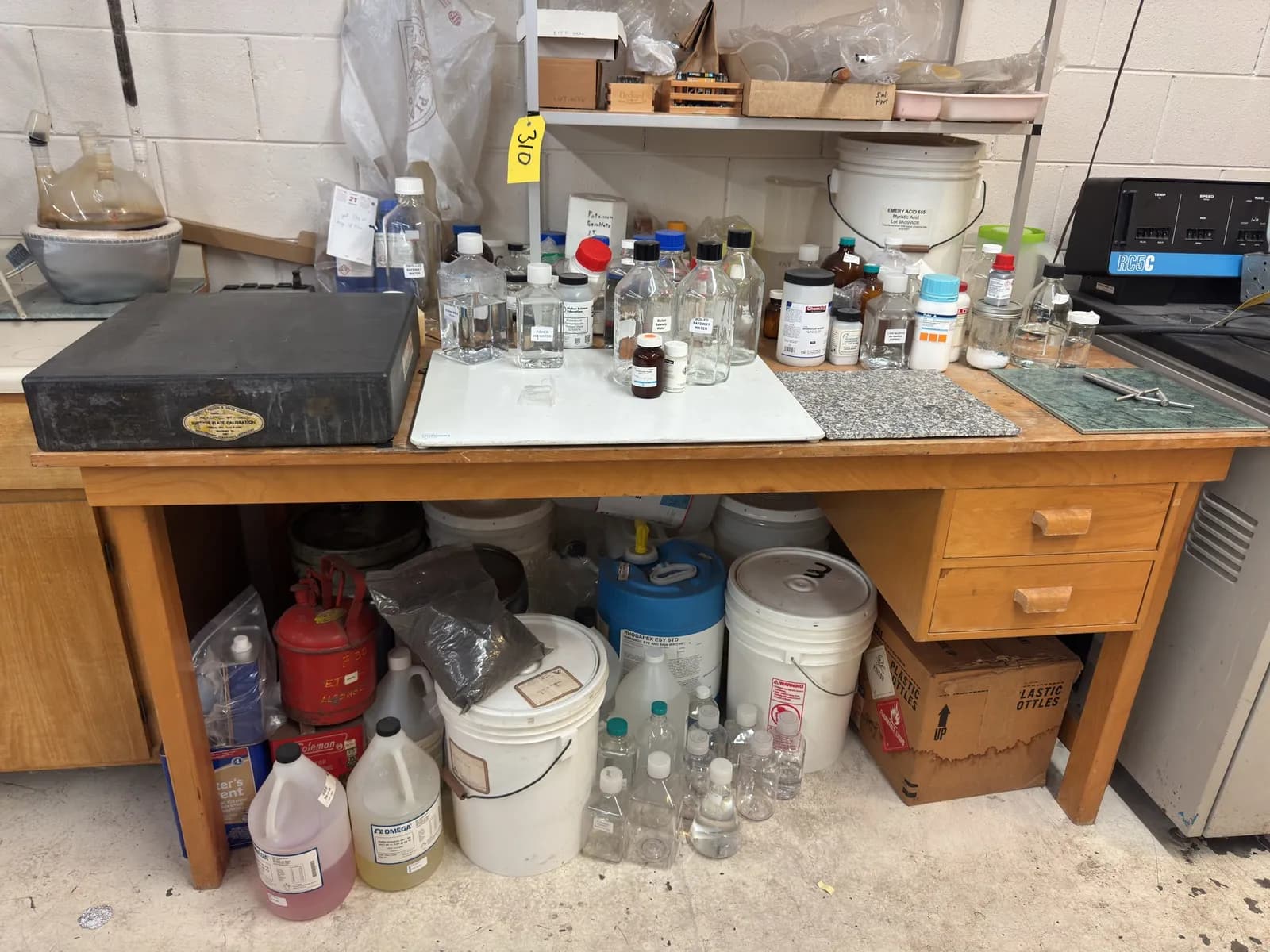 wood-desk-with-contents-calibration-stone-assorted-chemicals-glassware-and-more-551392