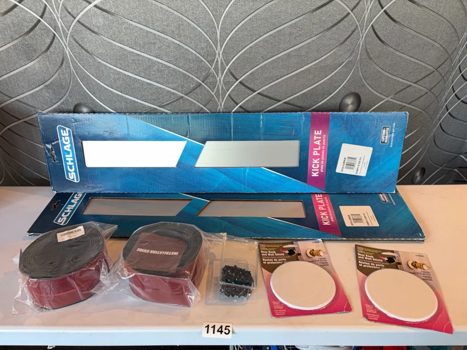 assorted-finishing-supplies-2-kick-plates-2-rolls-of-10-black-peel-and-stick-floor-transition-cable-clips-and-2-door-knob-shields-2935a4