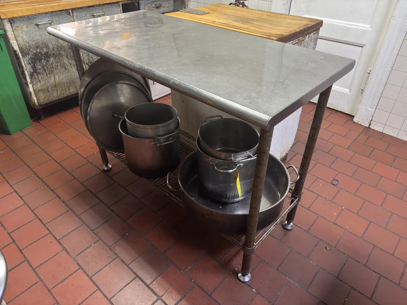 stainless-steel-table-with-pots-and-pans-f92bb0