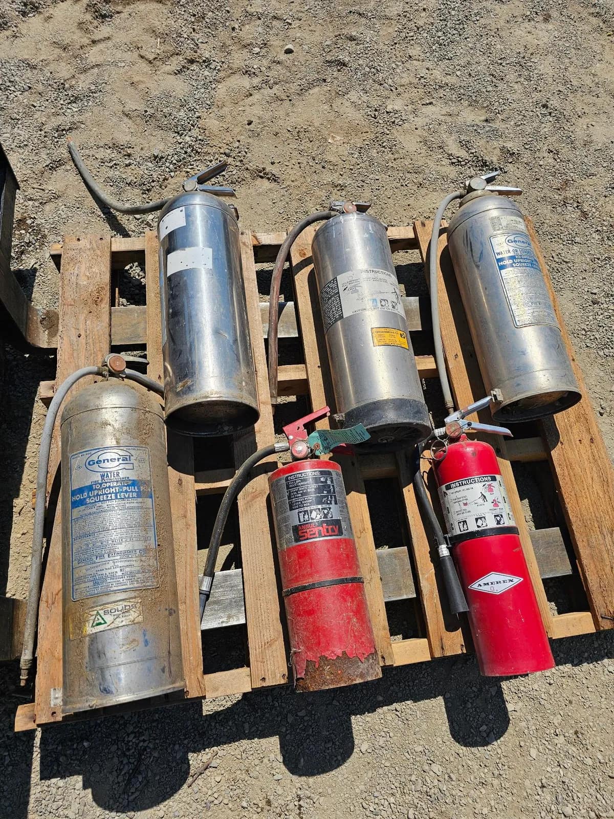 assorted-fire-extinguishers-on-wooden-pallet-3701f5