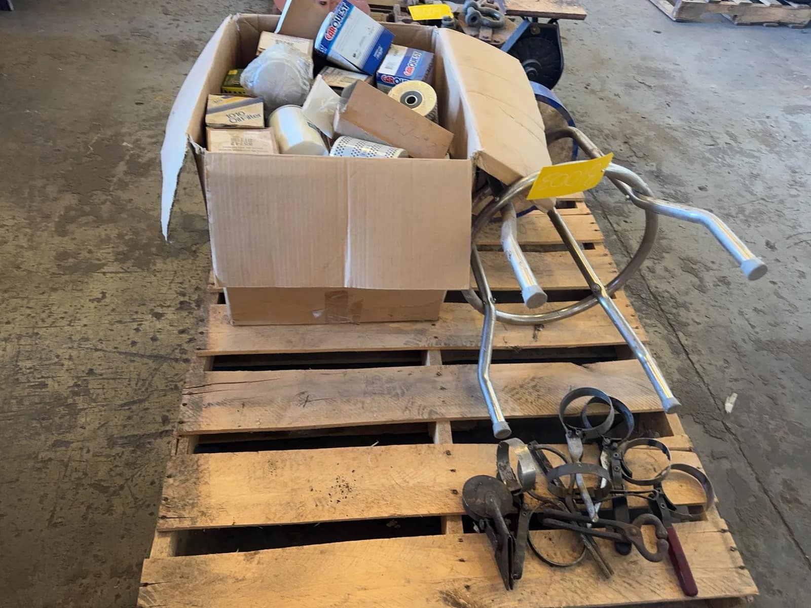 pallet-of-assorted-oil-filters-oil-filter-wrenches-and-stool-muh59k8g
