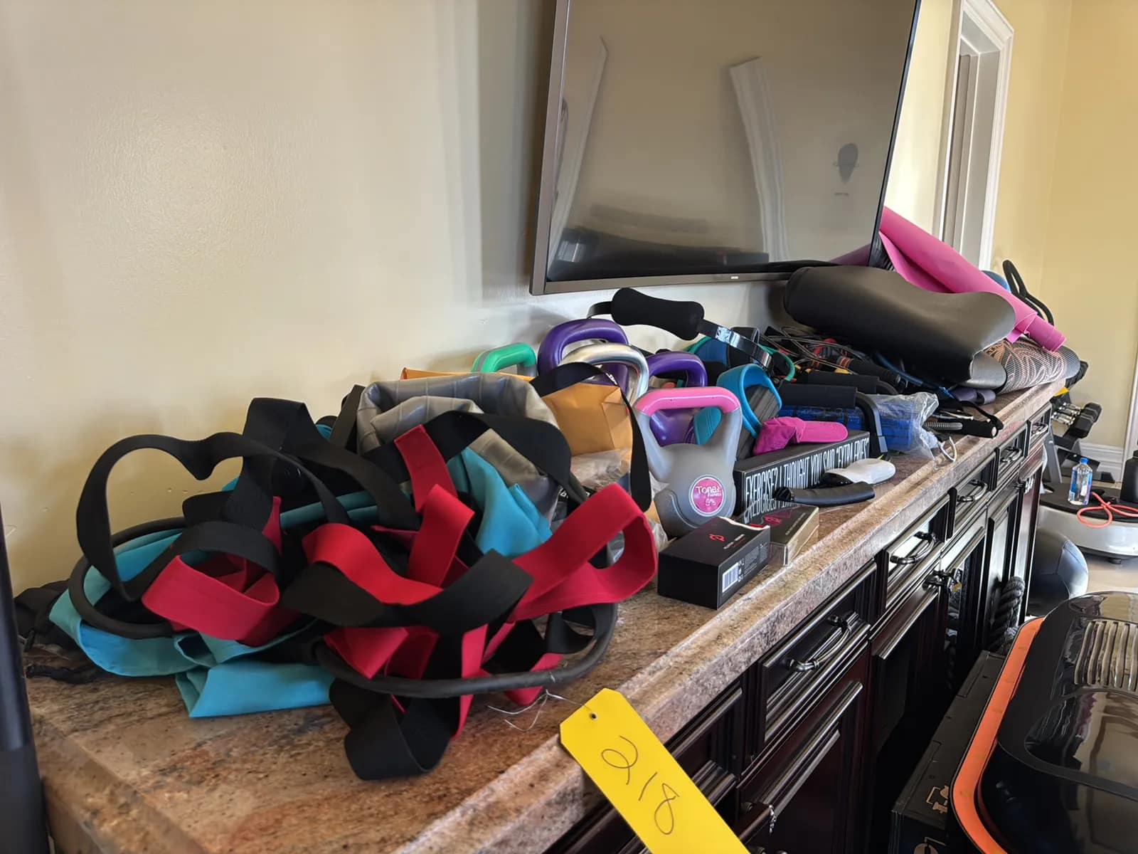 contents-of-countertop-kettlebells-rubber-bands-peloton-accessories-yoga-mats-pilates-equipment-and-machine-parts-mvh7xyxq